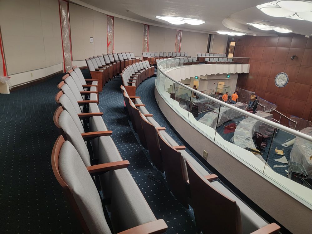 Curved balcony rows of fixed seating behind a glass rail