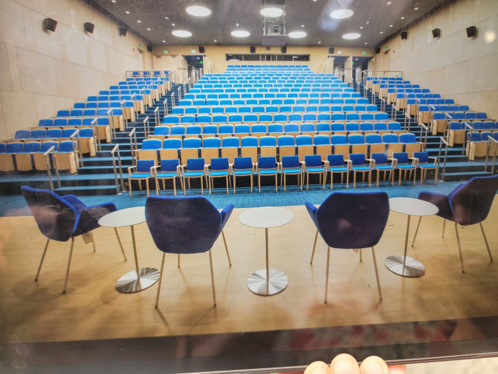 Tiered hall with blue fixed seating viewed from the front